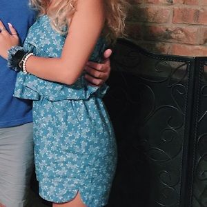 blue romper with white floral patterns